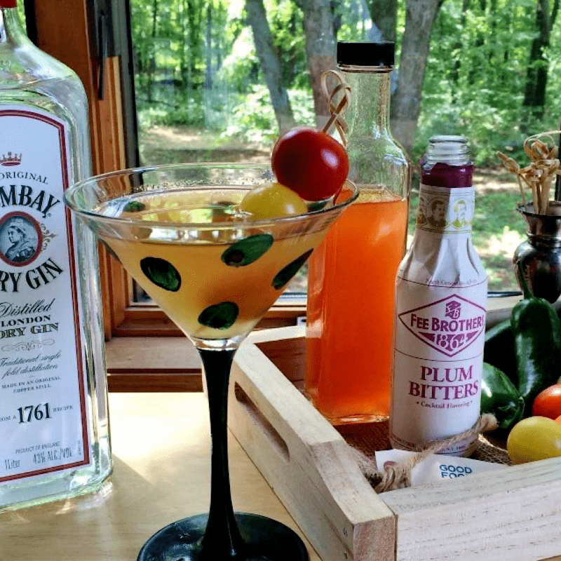 Ingredients to make a tomato martini and a martini in a glass.