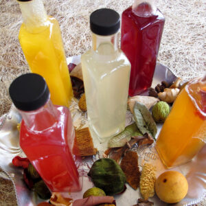 Five different homemade drink syrups on a platter. Five fruit flavored drink syrups for tea, coffee, sparking water or cocktails.