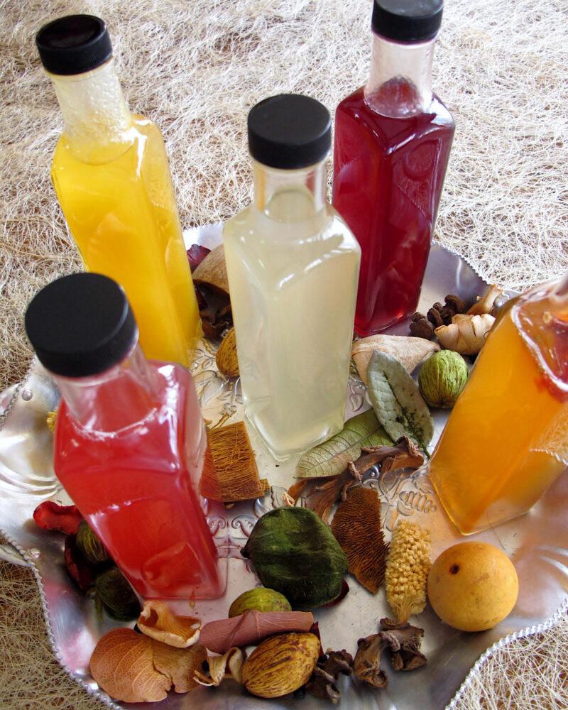 Five different homemade drink syrups on a platter. Five fruit flavored drink syrups for tea, coffee, sparking water or cocktails.