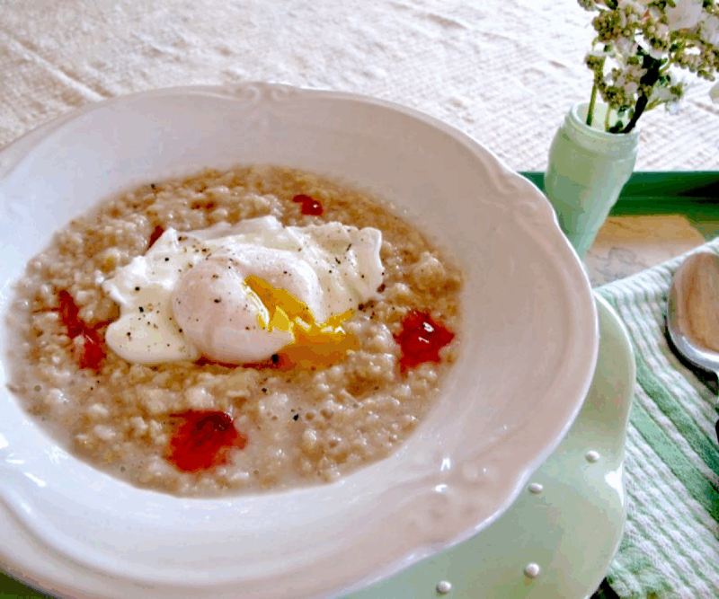 Oatmeal with a poached egg on top and dollops of raspberry hot pepper jelly.
