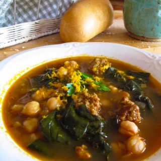 Bowl of soup with chickpeas, spinach and chorizo