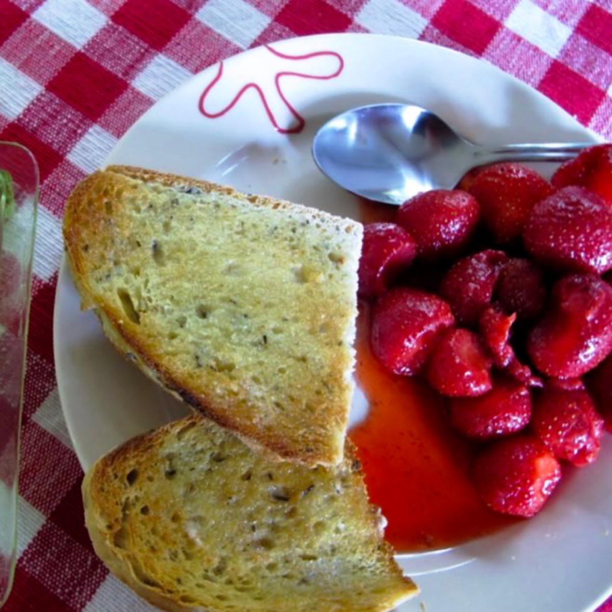Fresh strawberries with balsamic vinegar sauce on breakfast plate