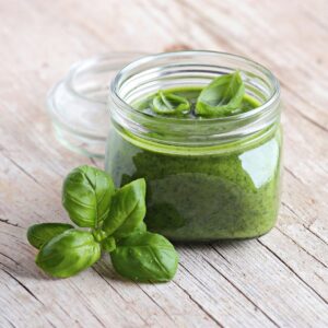 Jar of classic pesto made with fresh basil.