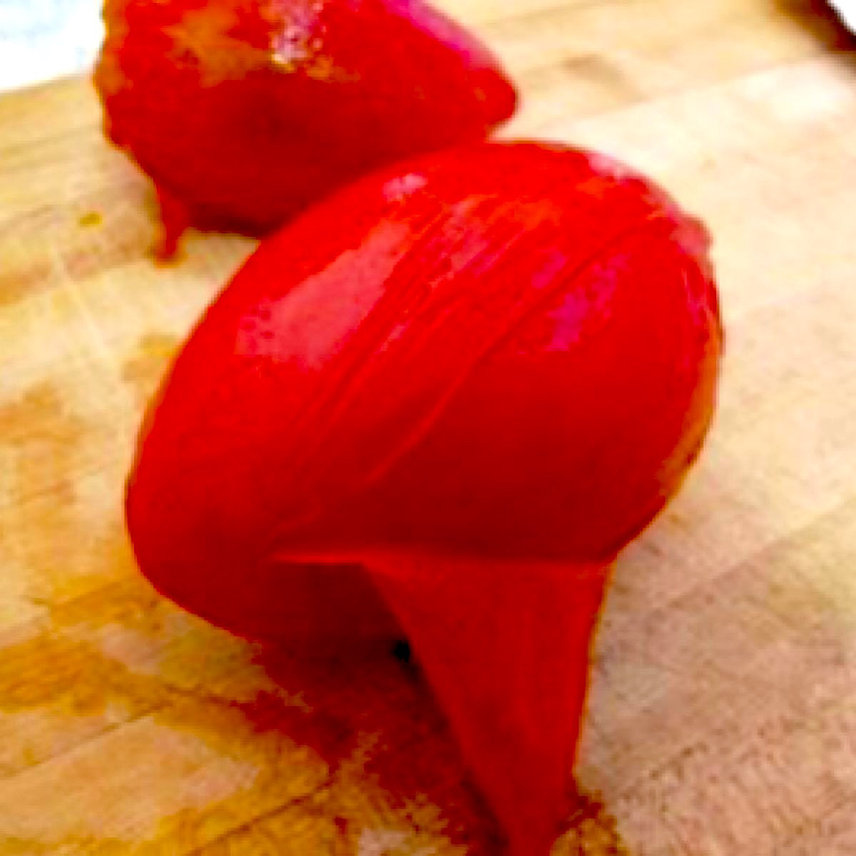 Roma tomato after being blanched and starting to peel.