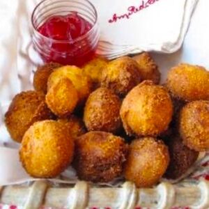 Basket of hush puppies with raspberry hot pepper jelly