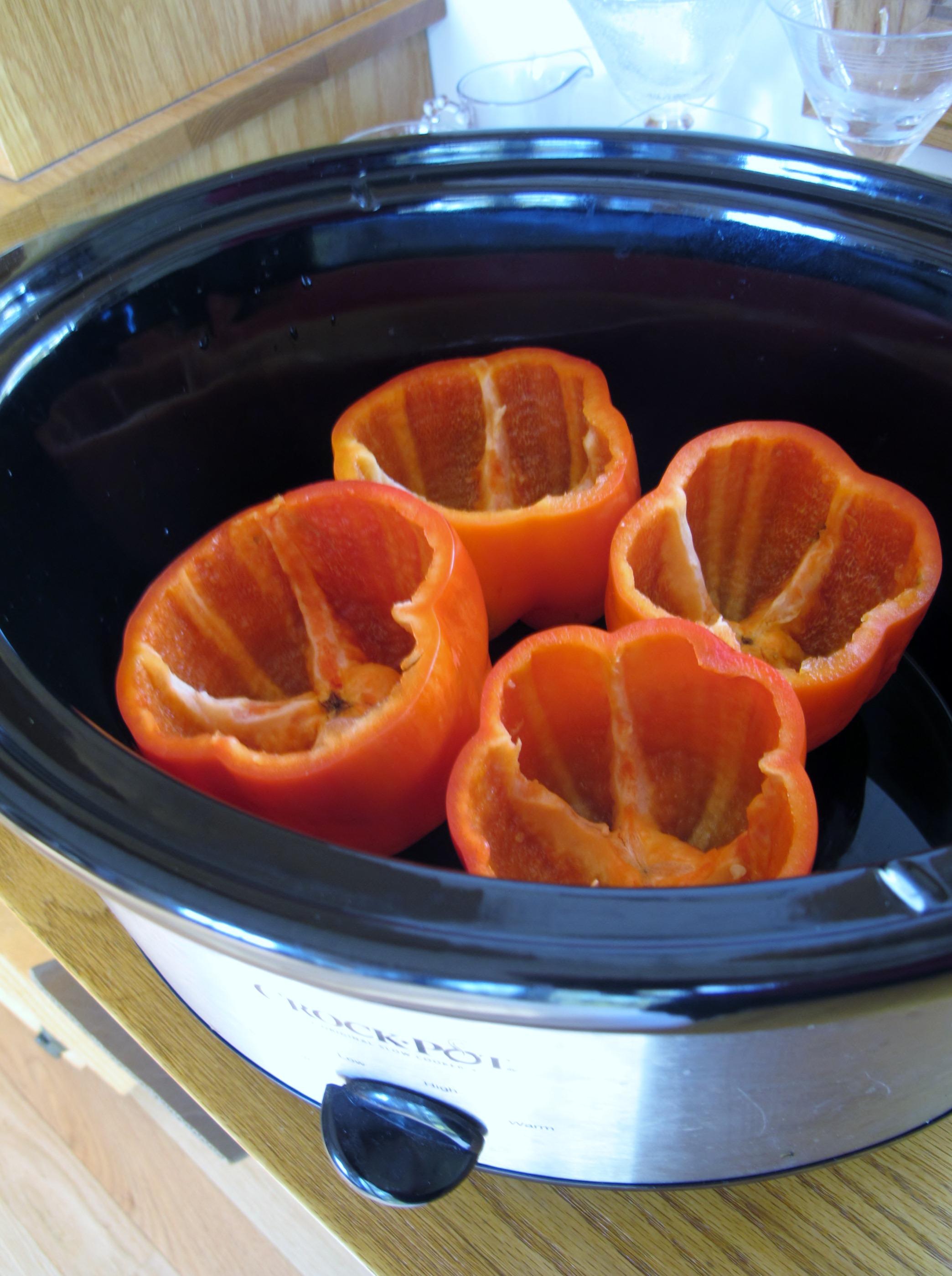 Red bell eppers in crock pot ready for stuffing