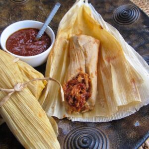 Open tamale showing the inside filling