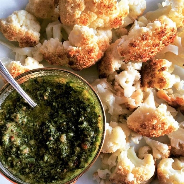 Roasted cauliflower with a side of chimichurri sauce