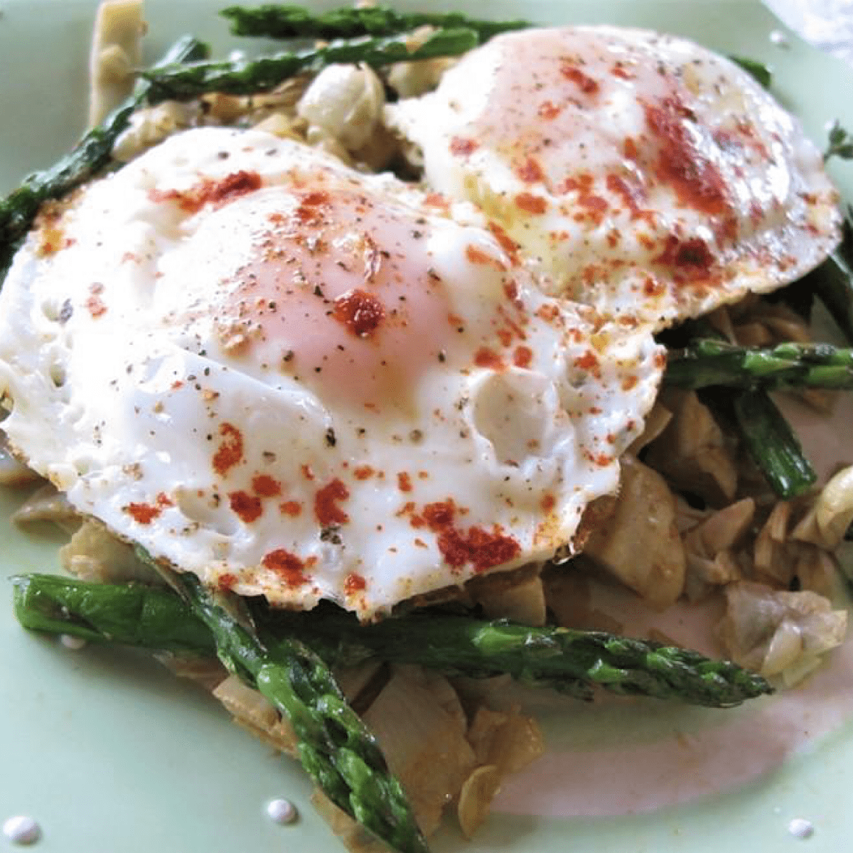 Breakfast of eggs on a bed of asparagus and artichoke hearts