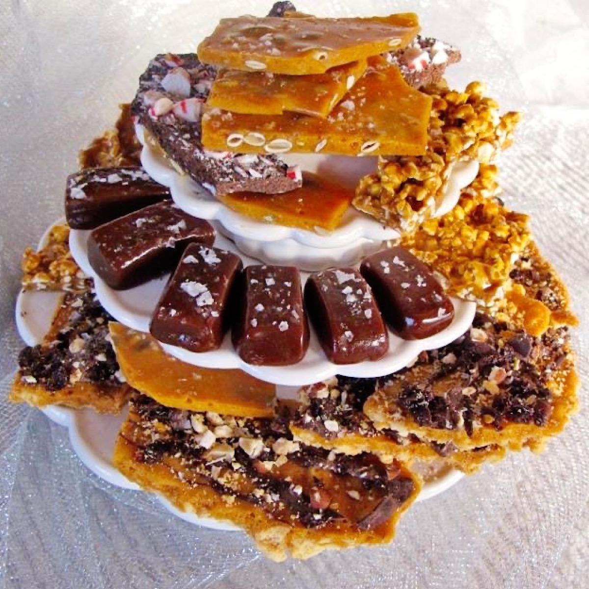 Peanut brittle, chocolate bark and bourbon caramels on a tiered candy dish