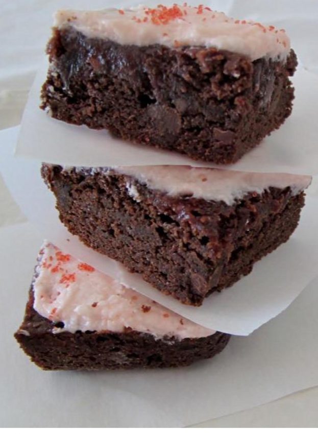 3 stacked chocolate brownies with strawberry rosewater frosting