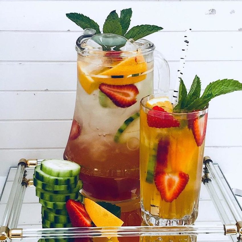 Pitcher of Sangria with cucumbers and Pimms Cup