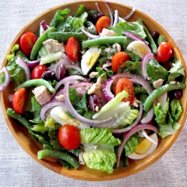 Tuna Niçoise salad in a large wooden bowl.