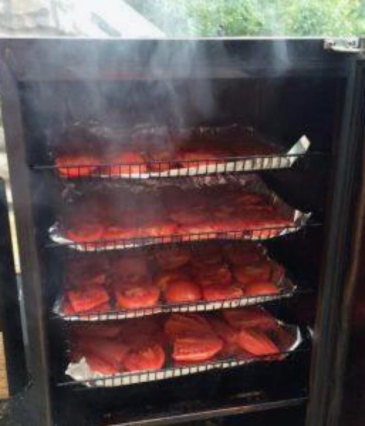 Heirloom tomatoes smoking in a Bradley smoker