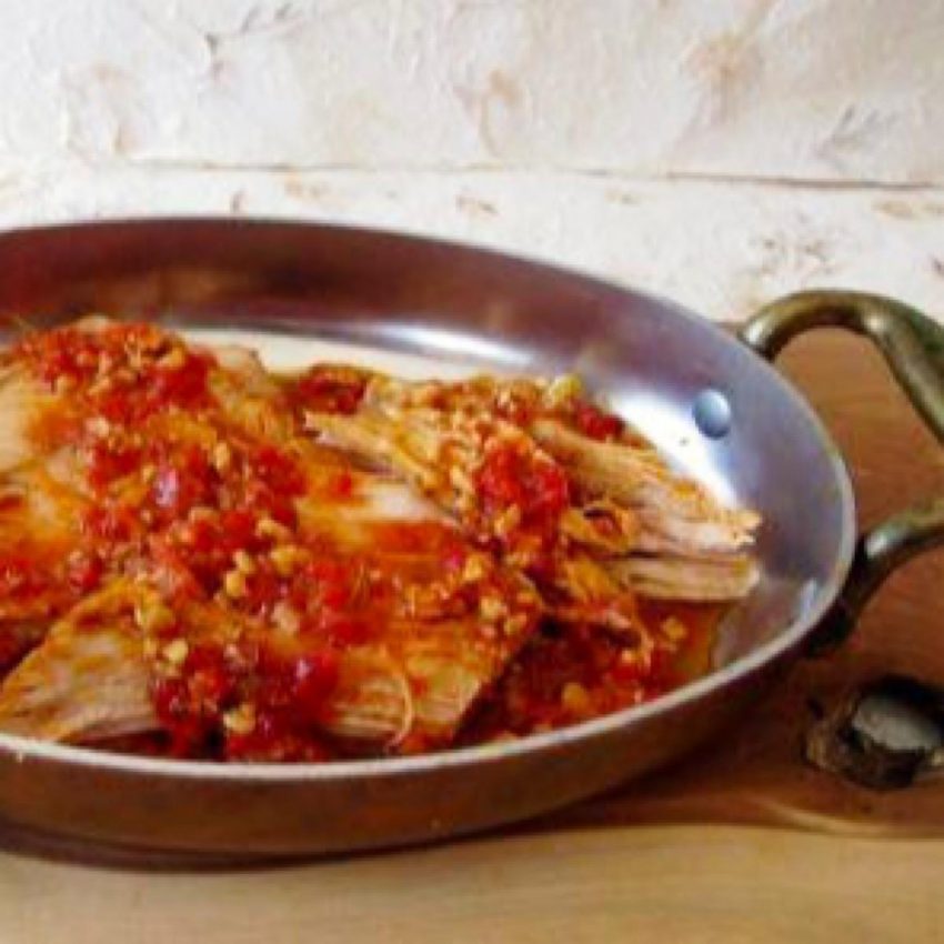 Shredded pork topped with Romesco sauce