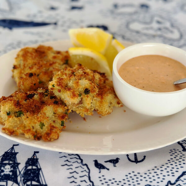 3 fish cakes on a white plate with Southern comeback dipping sauce.