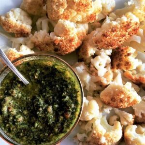 Chimichurri sauce with roasted cauliflower together on a dish