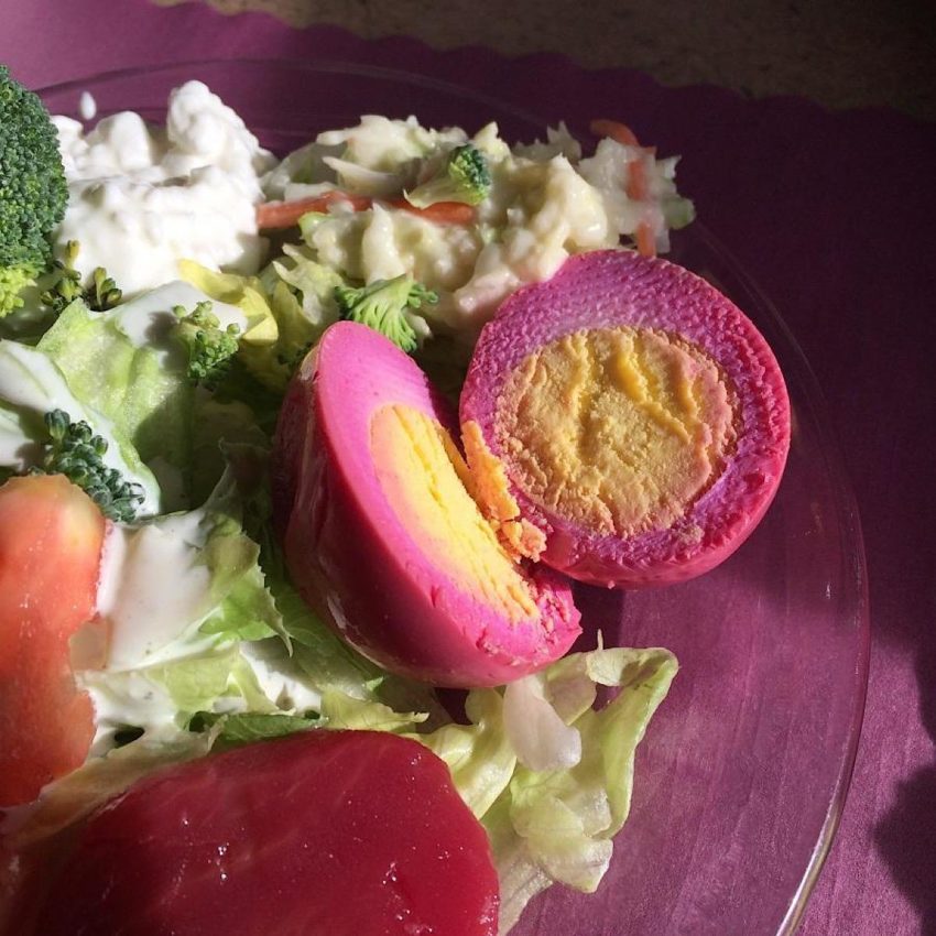 Low carb pickled beet eggs cut in half on a salad