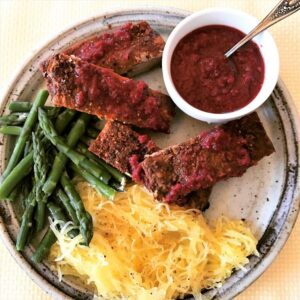 Dinner plate of spare ribs with low carb cranberry BBQ Sauce, asparagus & spaghetti squash