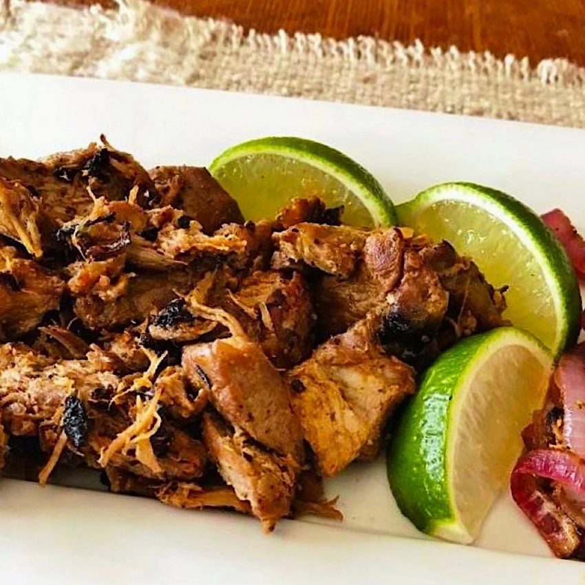 Slow cooked pork carnitas with side of pickled onions