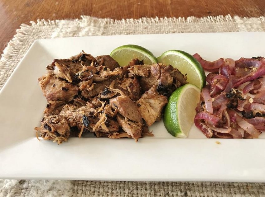 low carb carnitas on a plate with carmelized onions