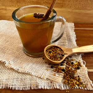 Cup of turmeric tea with tea ingredients on the spoon