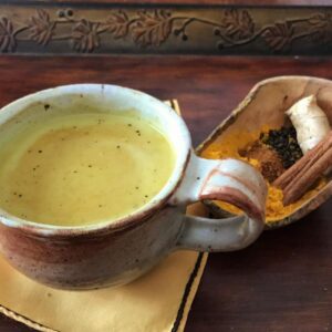 Cup of golden milk latte with turmeric and chai spices from HeathGlen Farm