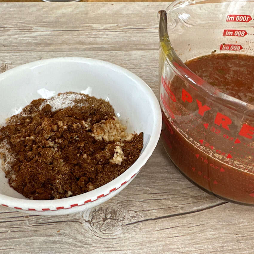 Bowl of Mexican spices and 2 cups enchilada sauce in Pyrex container.