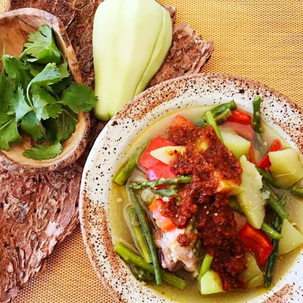 Chicken mole amarillo with chayote squash in a bowl