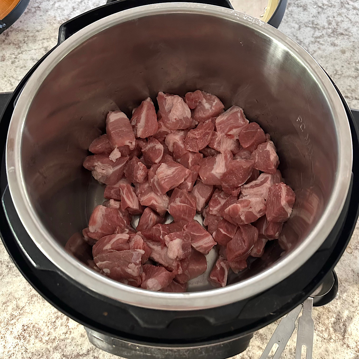 Pork cubes in an instant pot with a little liquid