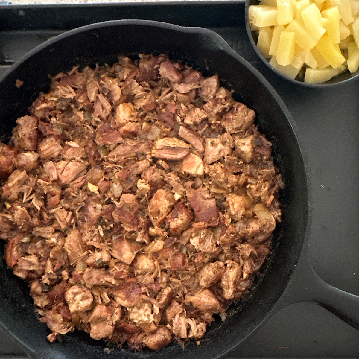 Pork al pastor filling cooking in skillet