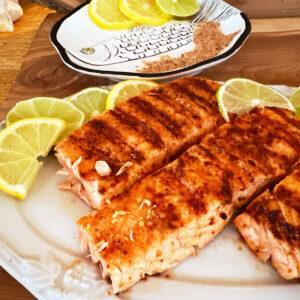 3 filets of Mexican spiced salmon made on an indoor grill with lemon and lime slices.