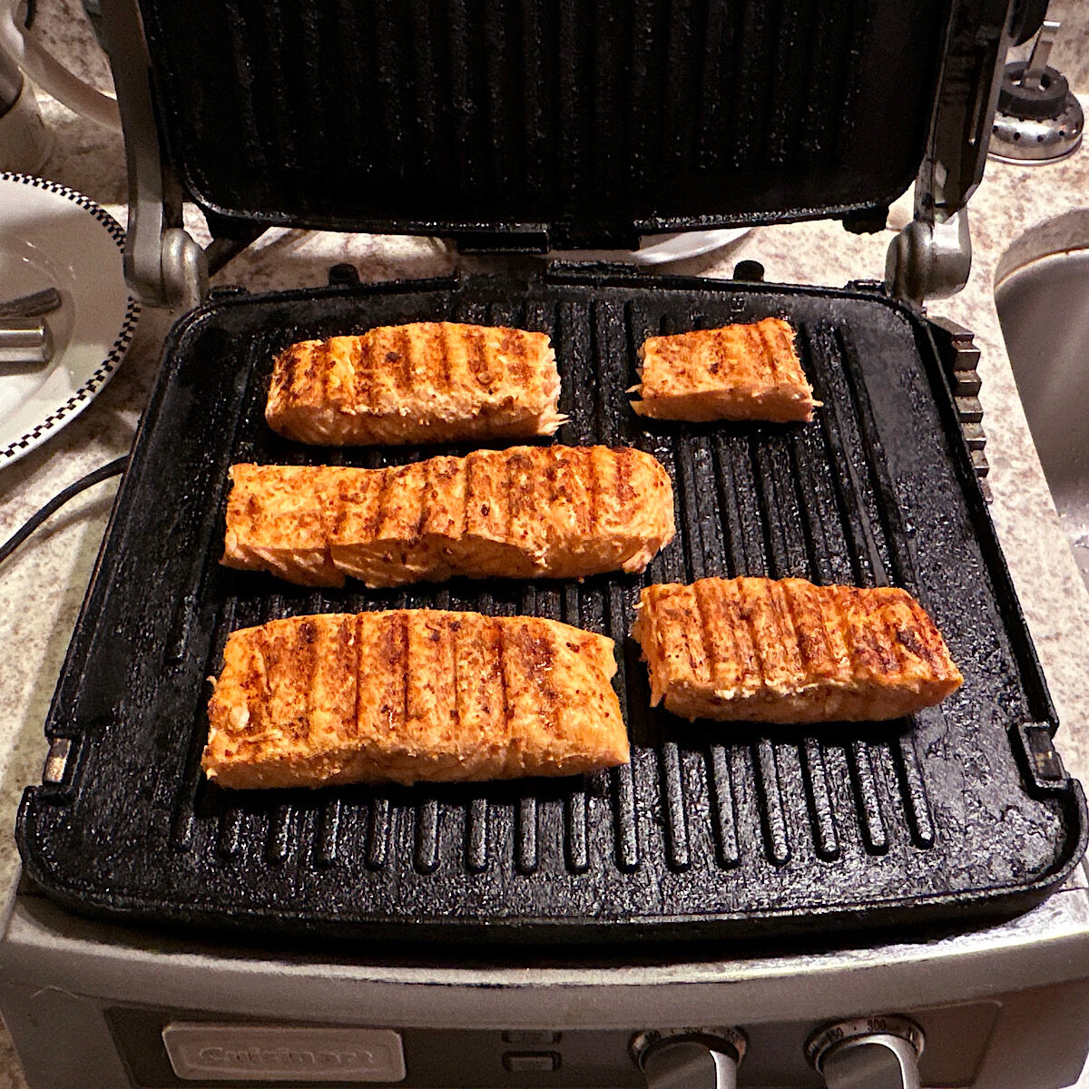 5 salmon filets after finished grilling on the Cuisinart griddler.