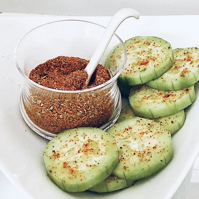 Chile lime salt sprinkled on slices of cucumbers
