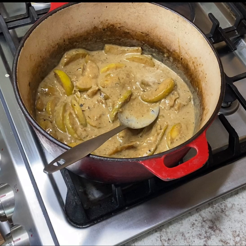 Large pot with browned apples, onions, cream and mustard, which is the base for pheasant Normandy.