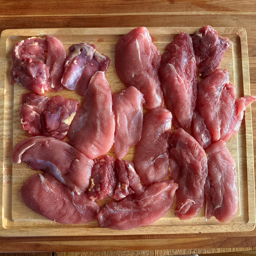 3 lbs. of salted pheasant pieces on a cutting board.