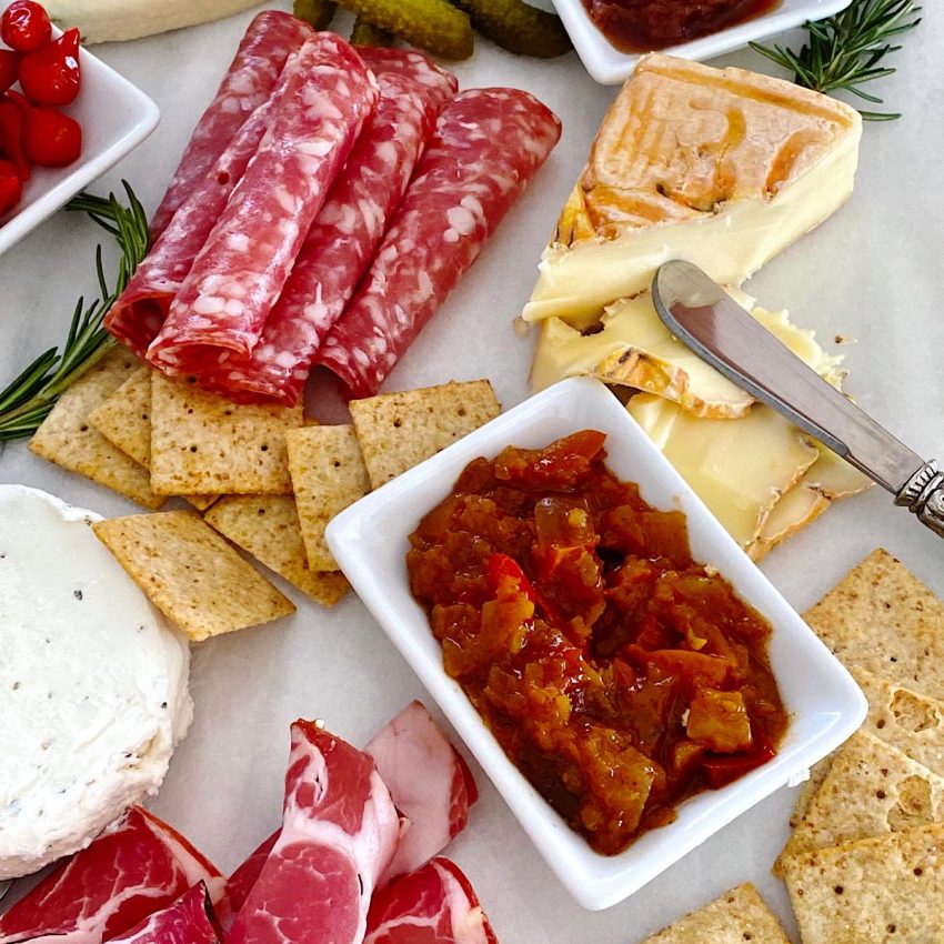 Small cheese plate with sweet red pepper chutney and charcuterie