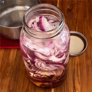 Red onions with pickling ingredients ready to marinate