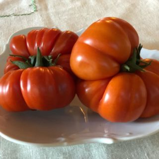 Two costoluto heirloom tomatoes on a plate