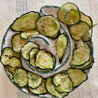 Dish of salt and vinegar cucumber chips dried in dehydrator