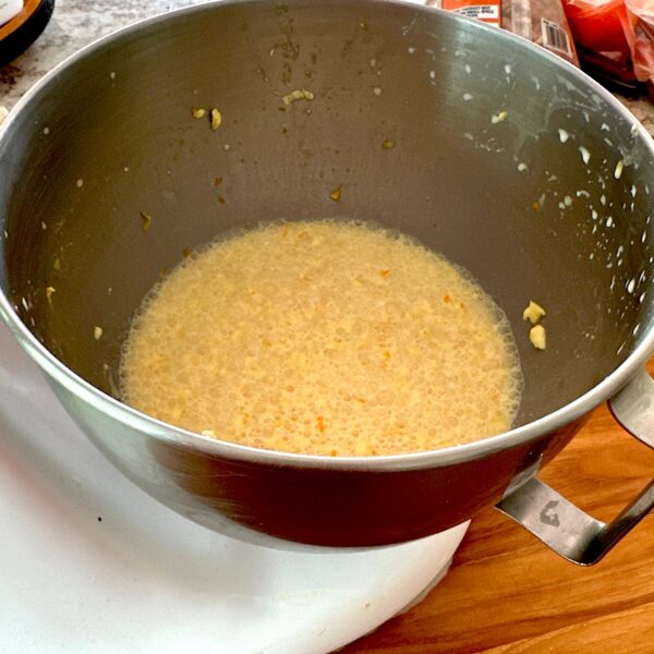 Stand mixer bowl of egg custard mixture.