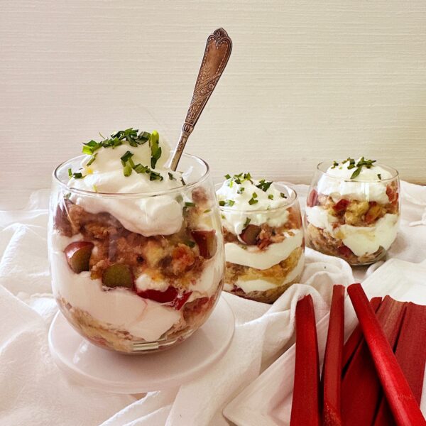 Rhubarb custard with crisp topping and layered with whipped cream and topped with tarragon.