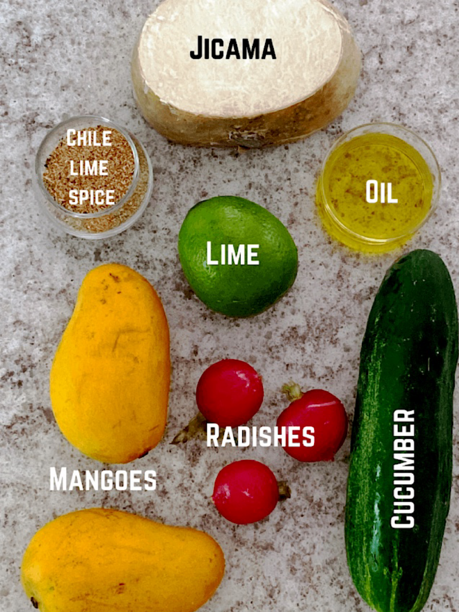 Ingredients for Mexican fruit salad with labels on a granite counter.