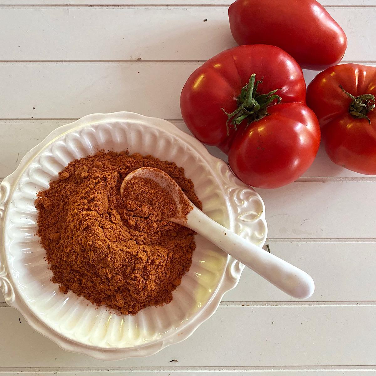 Bowl of tomato powder and 3 heirloom tomatoes