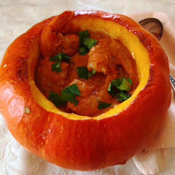 Hollowed out pumpkin filled with shrimp soup.