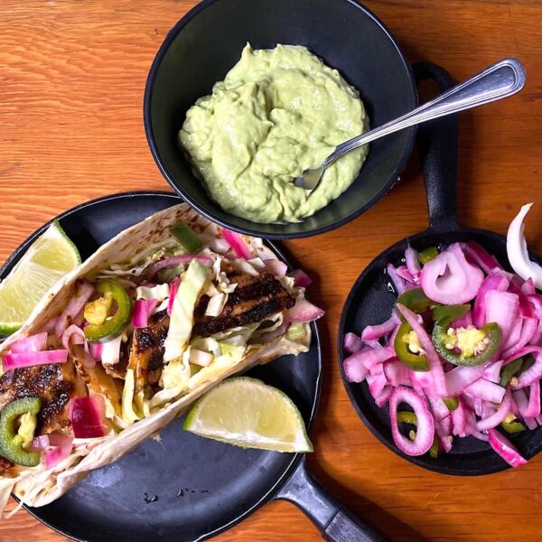 Fish tacos with avocado cream and pickled onions