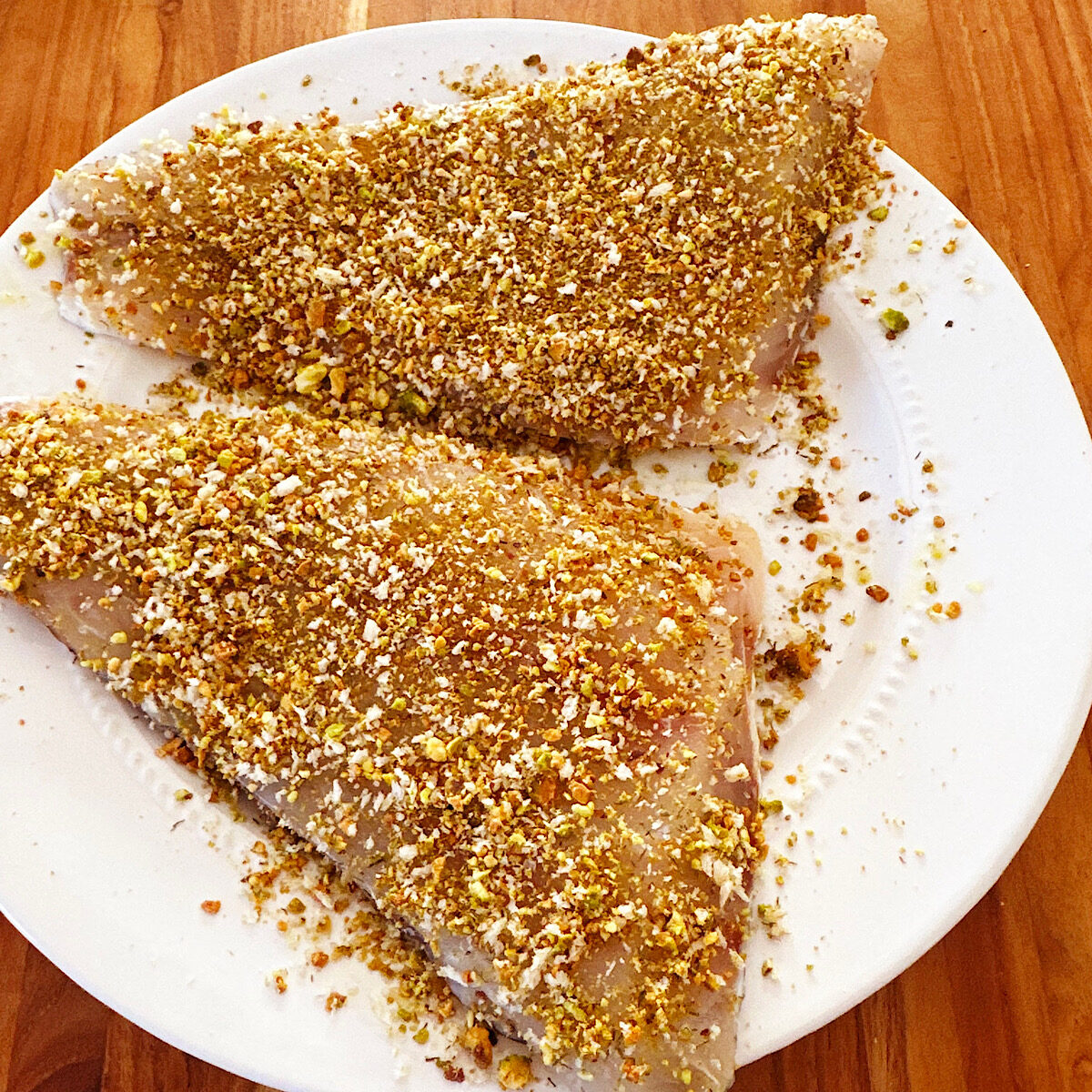 2 large red snapper filets coated with a pistachio nut crust.