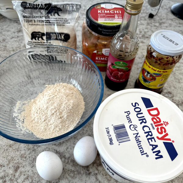 Ingredients for high protein kimchi pancakes with sour cream pomegranate topping.