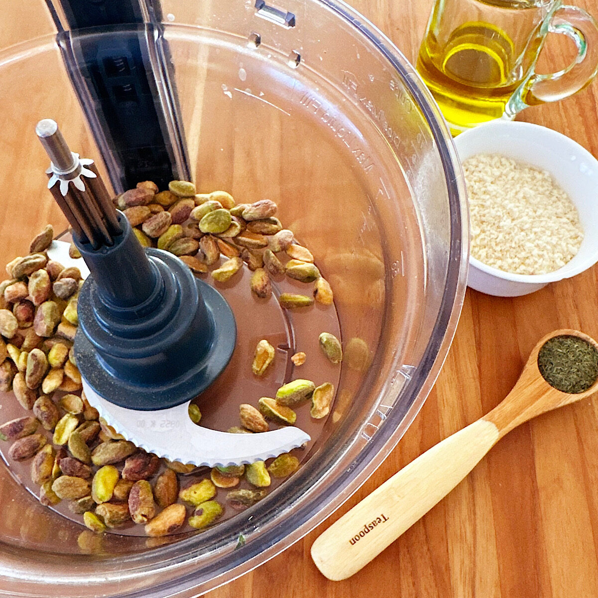 1/3 cup of shelled pistachio nuts in a food processor with panko and dill on the side.