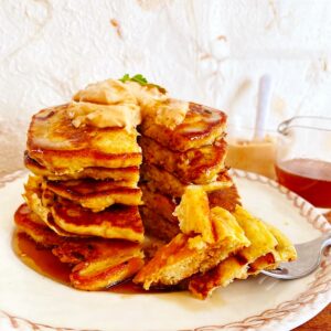 Stack of kim chi high protein pancakes with sour cream-pomegranate topping.